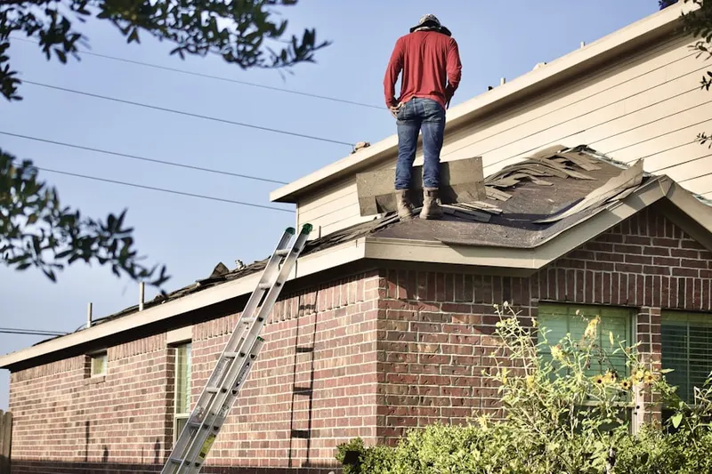 Professional roofer working on a residential roof in Edwards